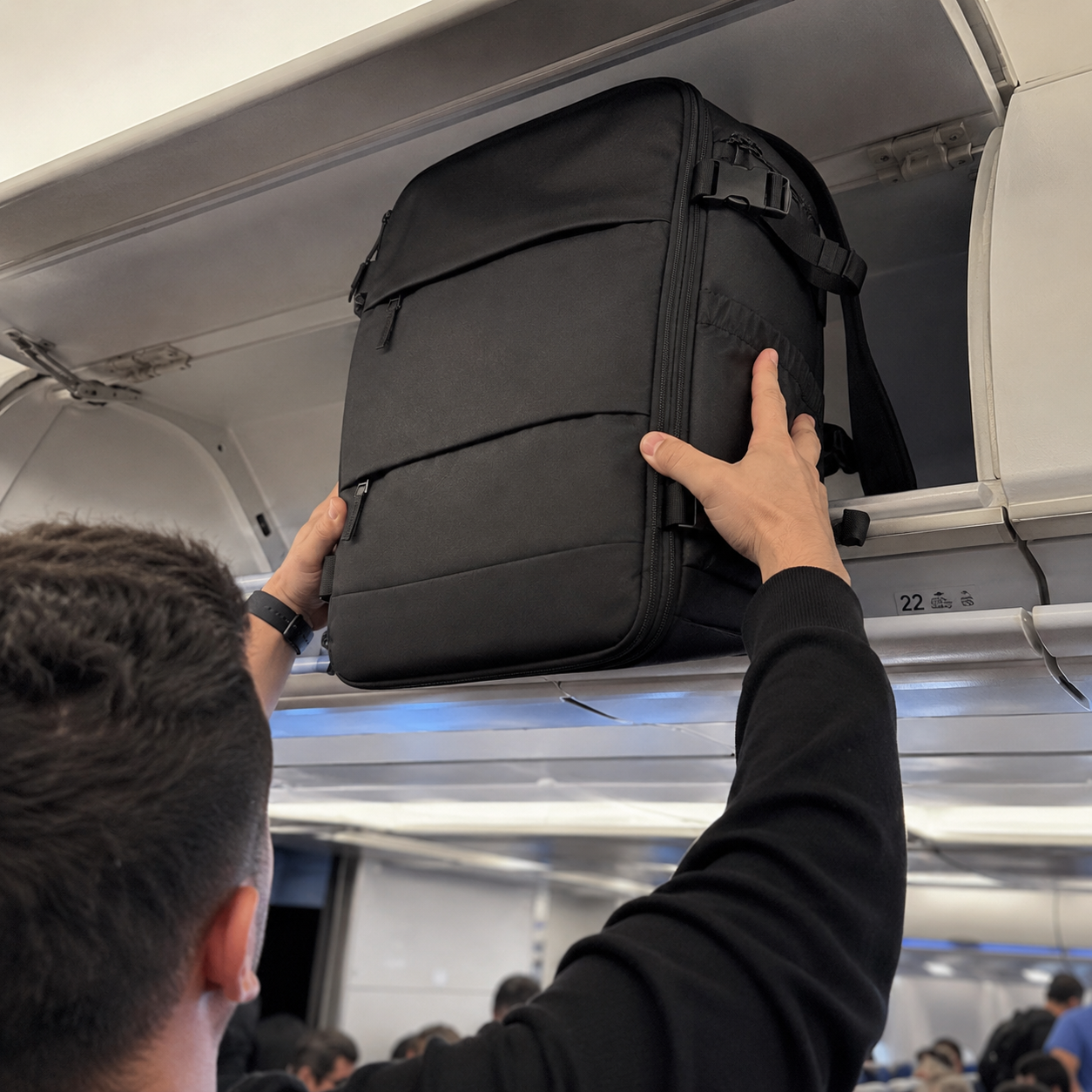 Lifting the backpack into the airplane overhead bin