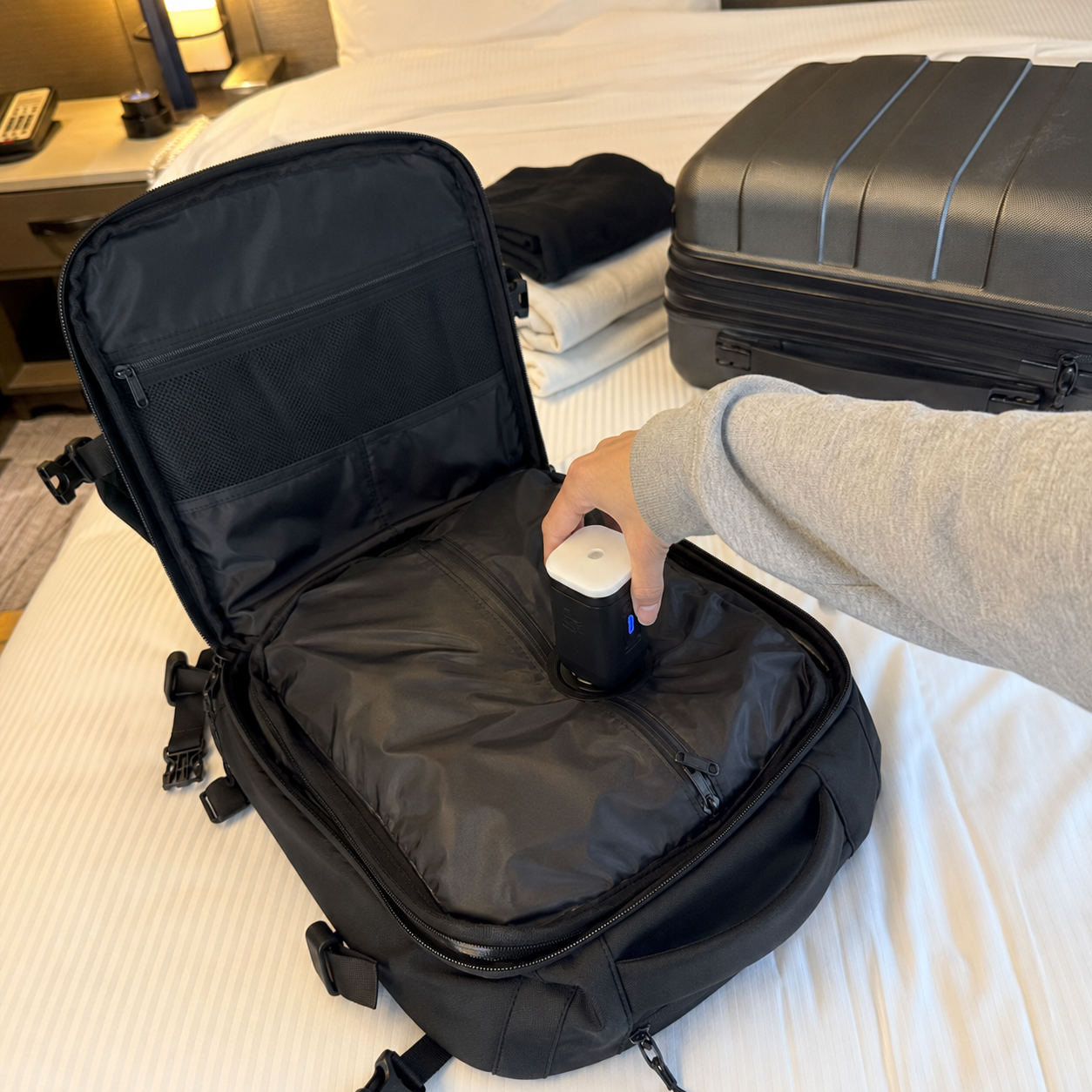 Backpack open and being packed
